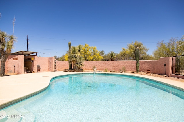 view of pool with a fenced in pool and fence