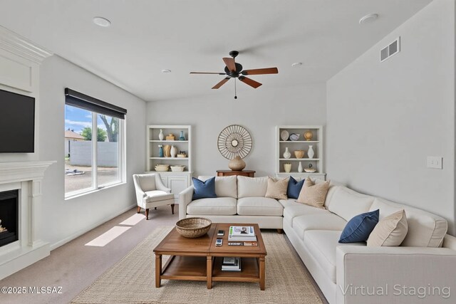 8972 E Mcmurray Pl, Tucson, AZ 85730 - living room featuring a ceiling fan, a fireplace with raised hearth, light colored carpet, and lofted ceiling