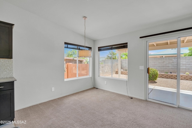 8972 E Mcmurray Pl, Tucson, AZ 85730 - unfurnished dining area with light colored carpet and baseboards