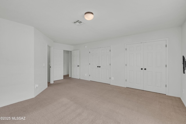 8972 E Mcmurray Pl, Tucson, AZ 85730 - unfurnished bedroom with carpet floors, multiple closets, and baseboards