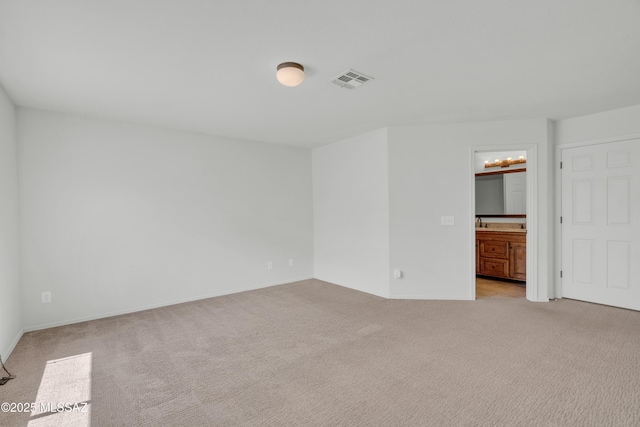 8972 E Mcmurray Pl, Tucson, AZ 85730 - unfurnished bedroom featuring light carpet, ensuite bath, and baseboards