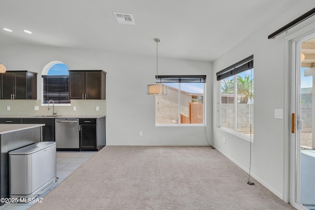 8972 E Mcmurray Pl, Tucson, AZ 85730 - kitchen with dishwasher, a sink, light countertops, tasteful backsplash, and pendant lighting