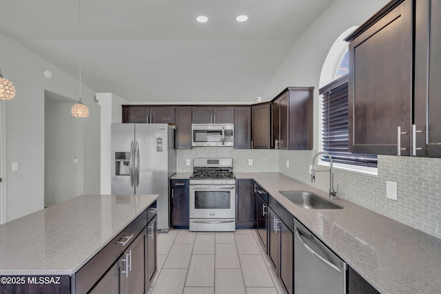8972 E Mcmurray Pl, Tucson, AZ 85730 - kitchen with stainless steel appliances, a sink, dark brown cabinetry, decorative backsplash, and recessed lighting
