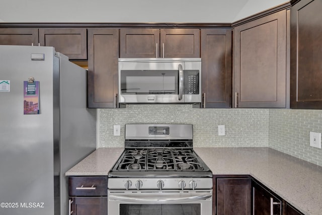 8972 E Mcmurray Pl, Tucson, AZ 85730 - kitchen featuring stainless steel appliances, dark brown cabinets, backsplash, and light stone counters
