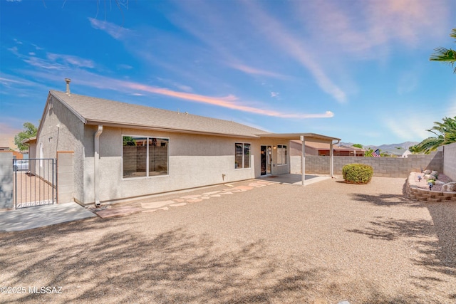 8972 E Mcmurray Pl, Tucson, AZ 85730 - back of house featuring a patio area, stucco siding, a fenced backyard, and a gate