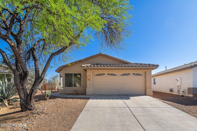 single story home featuring a garage, stucco siding, concrete driveway, and a tiled roof