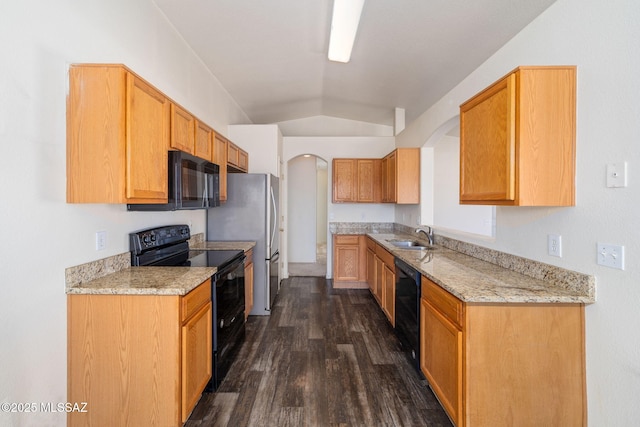 kitchen with a sink, arched walkways, lofted ceiling, dark wood-type flooring, and black appliances