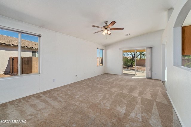 unfurnished room featuring carpet floors, ceiling fan, vaulted ceiling, and visible vents