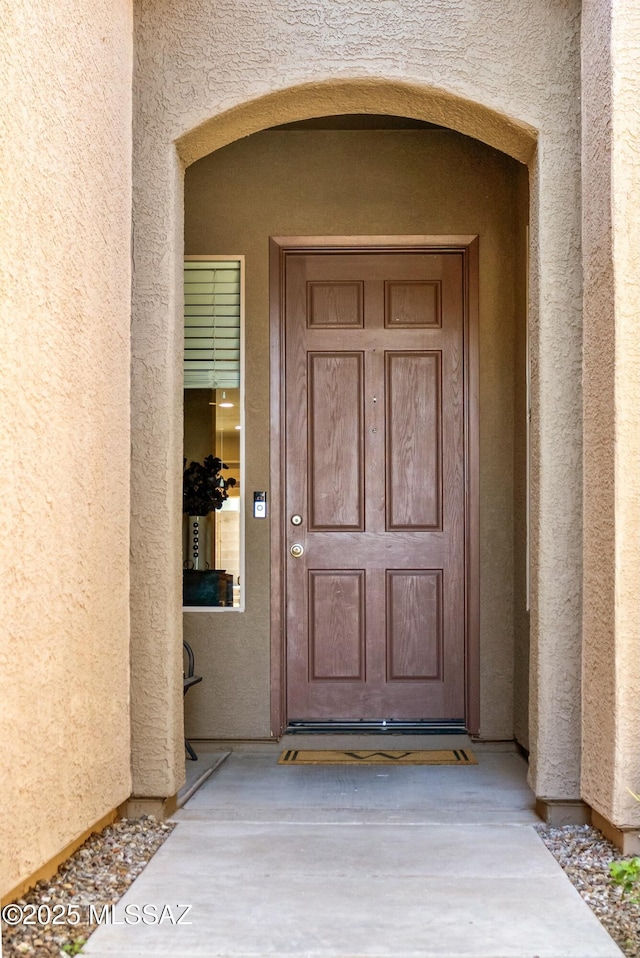 entrance to property with stucco siding