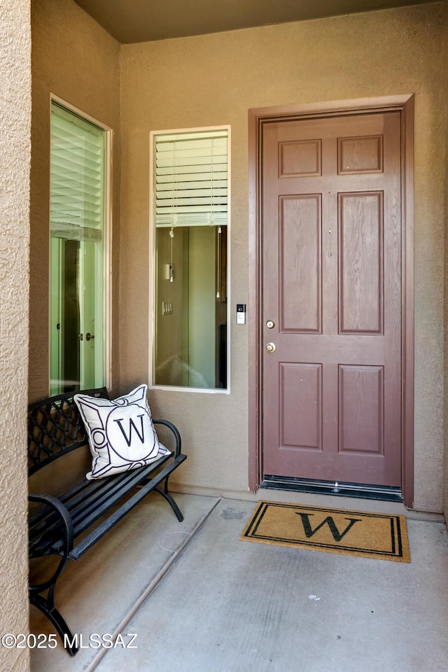 property entrance featuring stucco siding