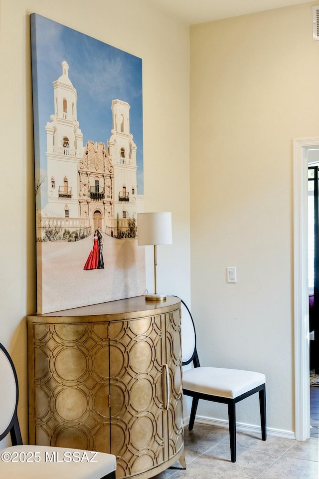 hallway with baseboards and visible vents