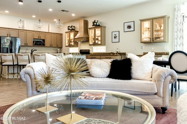 living area featuring recessed lighting and visible vents