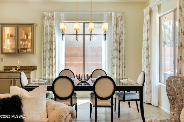 dining room featuring a chandelier and light tile patterned flooring