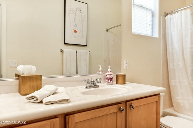 bathroom featuring shower / bath combination with curtain, vanity, and toilet