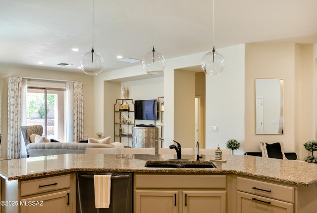 kitchen with stainless steel dishwasher, a sink, open floor plan, light stone countertops, and visible vents