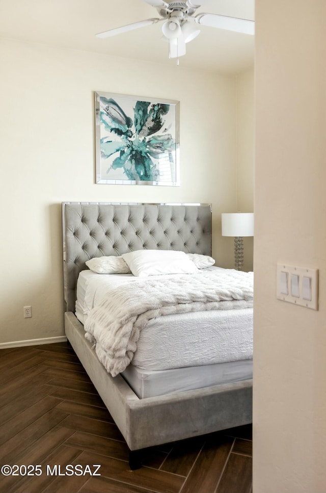 bedroom featuring baseboards and ceiling fan