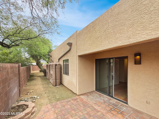 back of house featuring a patio, stucco siding, and a fenced backyard
