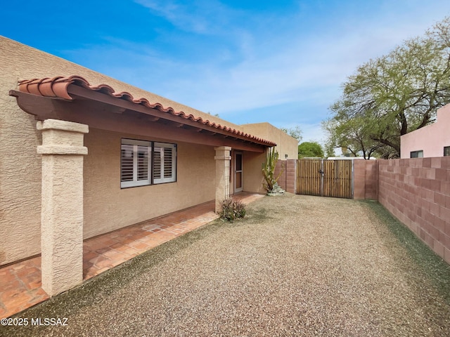 view of yard with fence, a patio, and a gate