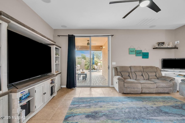living room featuring visible vents, ceiling fan, light tile patterned flooring, and baseboards
