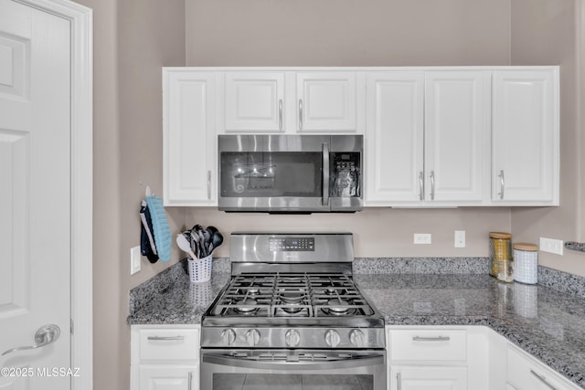 kitchen with white cabinets, dark stone counters, and stainless steel appliances