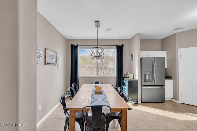dining room with a chandelier, visible vents, baseboards, and light tile patterned flooring