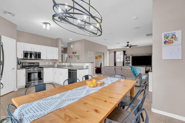 dining room with recessed lighting, light tile patterned floors, visible vents, and ceiling fan with notable chandelier