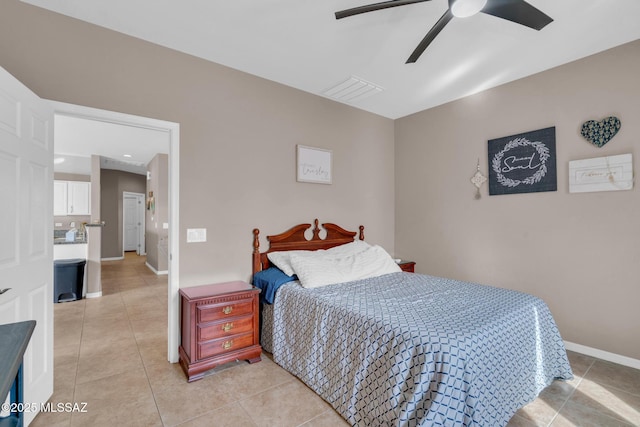 bedroom featuring light tile patterned floors, baseboards, and a ceiling fan