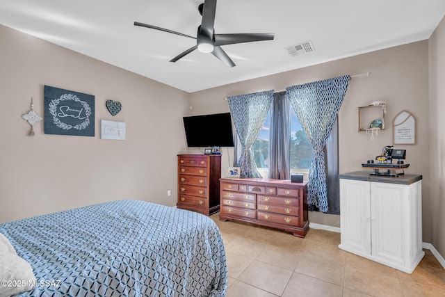 bedroom with visible vents, baseboards, a ceiling fan, and light tile patterned floors