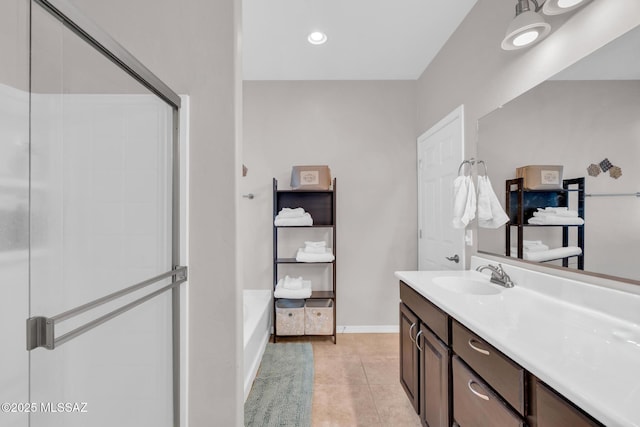 full bath featuring tile patterned floors, vanity, a shower with door, and baseboards