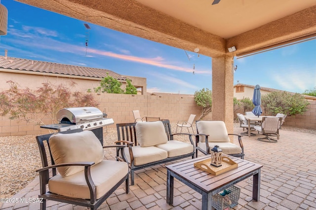 view of patio featuring outdoor dining space, outdoor lounge area, a fenced backyard, and area for grilling