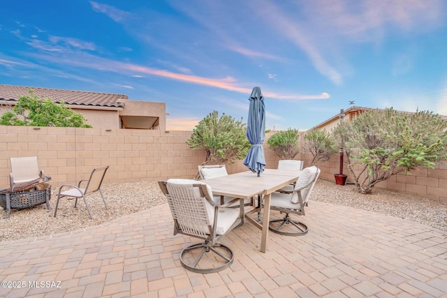 view of patio / terrace with an outdoor fire pit, a fenced backyard, and outdoor dining area