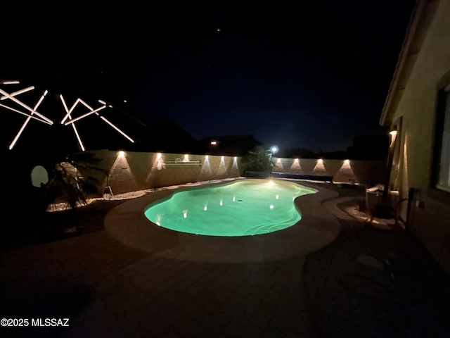 pool at twilight featuring a fenced in pool