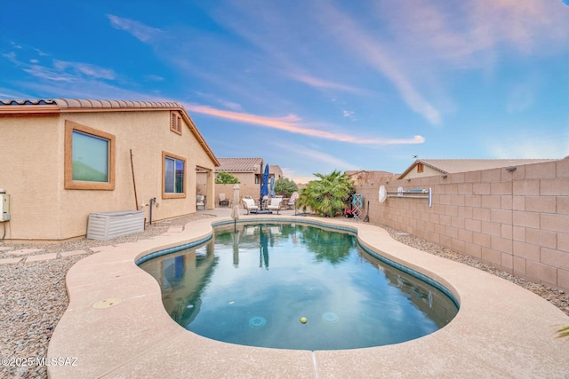 view of pool featuring a fenced backyard, a fenced in pool, and a patio area