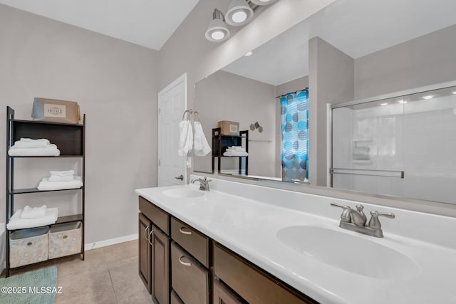 bathroom with a sink, tile patterned floors, double vanity, and a shower with shower curtain