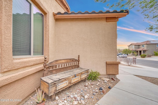 property exterior at dusk with stucco siding