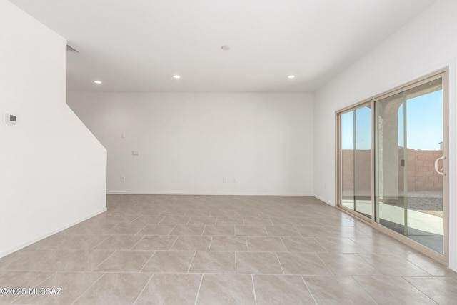 empty room with recessed lighting, light tile patterned floors, and baseboards
