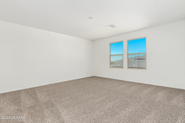 carpeted empty room with baseboards and visible vents
