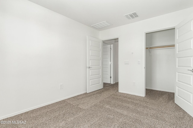 unfurnished bedroom featuring visible vents, baseboards, a closet, and carpet