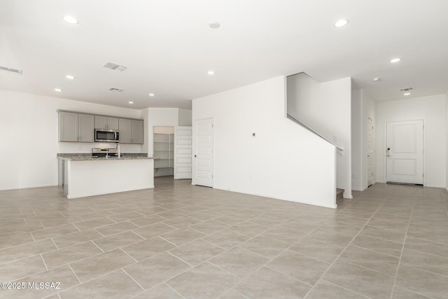 unfurnished living room featuring visible vents and recessed lighting