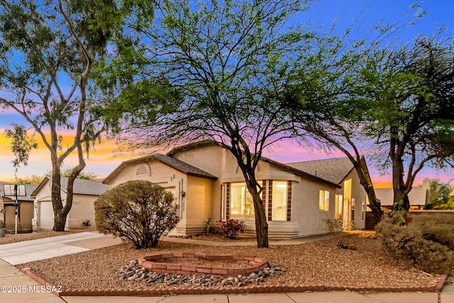 9157 E Autumn Sage St, Tucson, AZ 85747 - view of front of house featuring concrete driveway, stucco siding, and a garage
