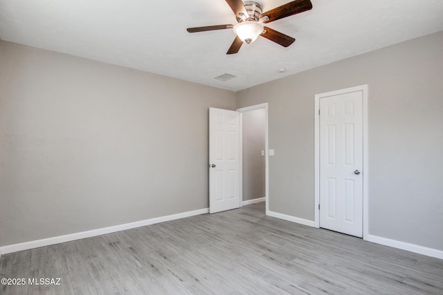 unfurnished bedroom featuring visible vents, baseboards, and light wood-type flooring