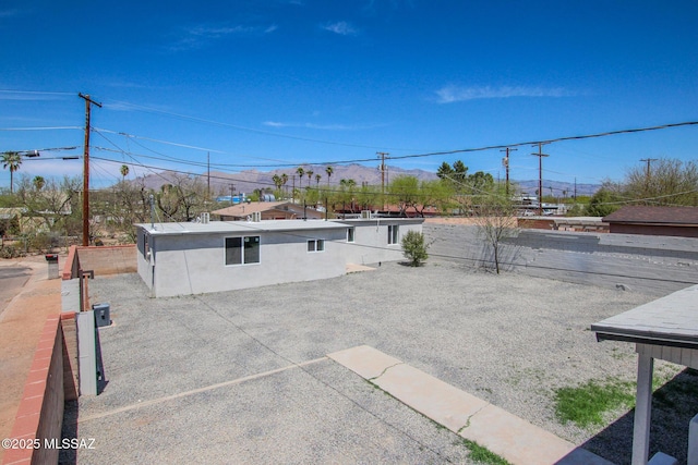exterior space with a mountain view and a fenced backyard