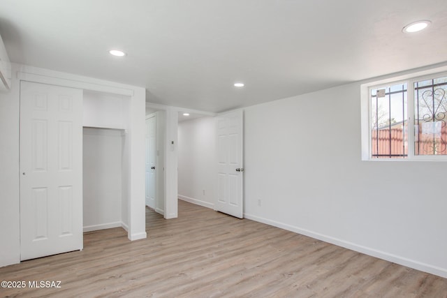 below grade area featuring recessed lighting, light wood-style flooring, and baseboards