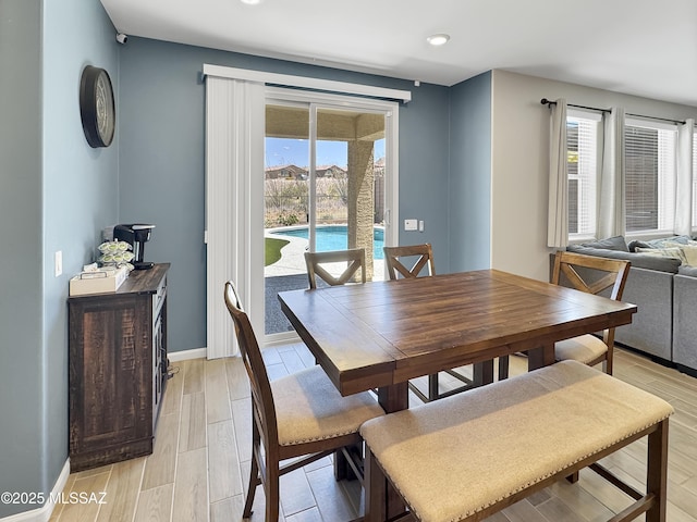 dining room with recessed lighting, baseboards, and light wood finished floors