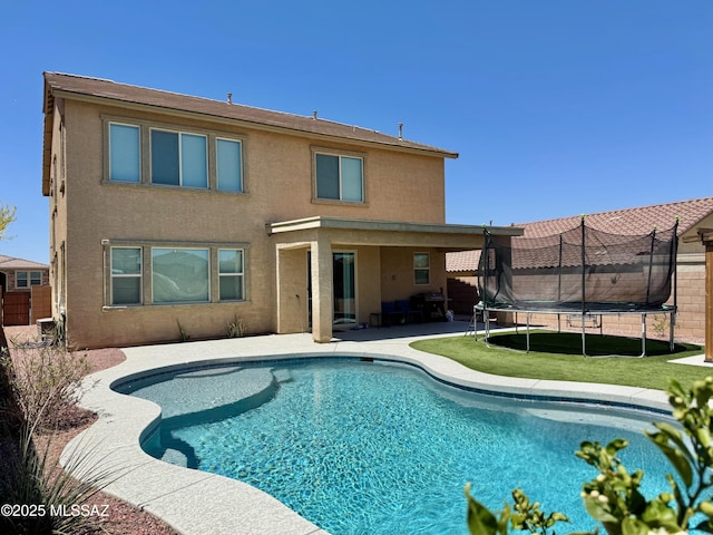 view of swimming pool featuring a fenced in pool, fence, a trampoline, and a patio area