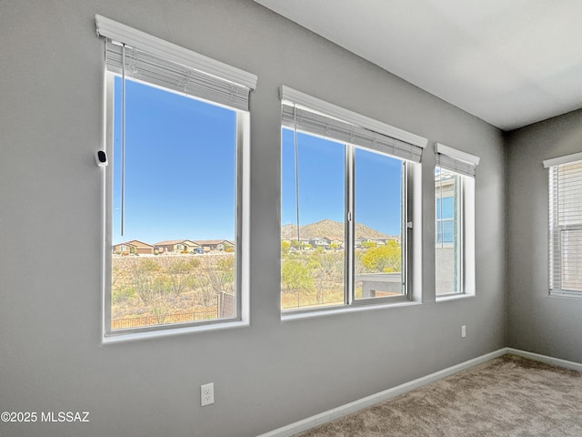 spare room with carpet floors and baseboards