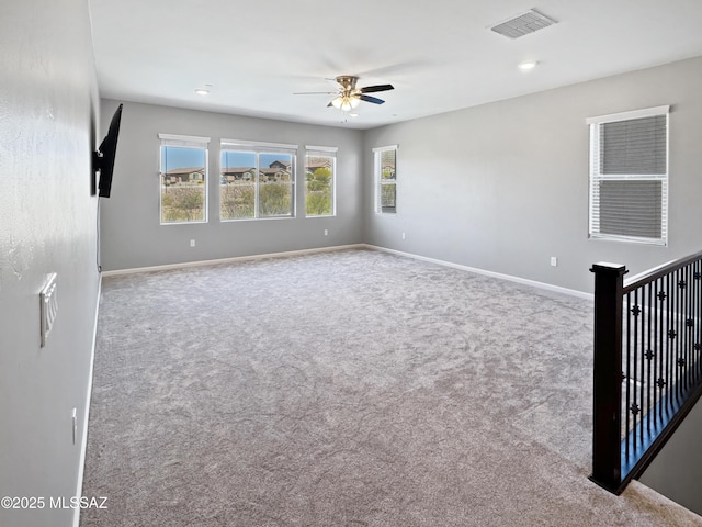 carpeted empty room with baseboards, ceiling fan, recessed lighting, and visible vents