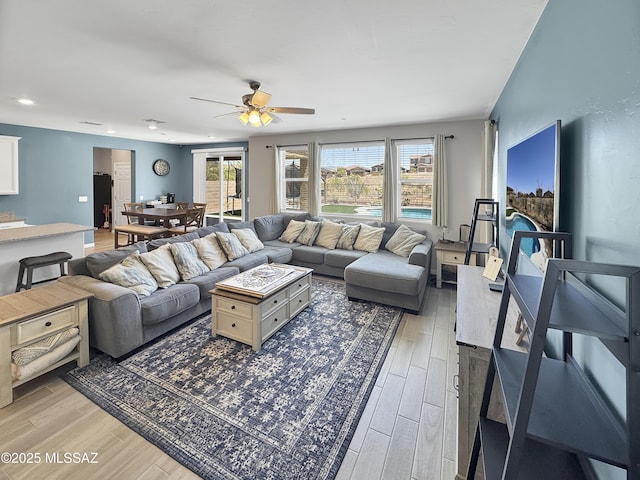 living area with recessed lighting, ceiling fan, and light wood-style floors