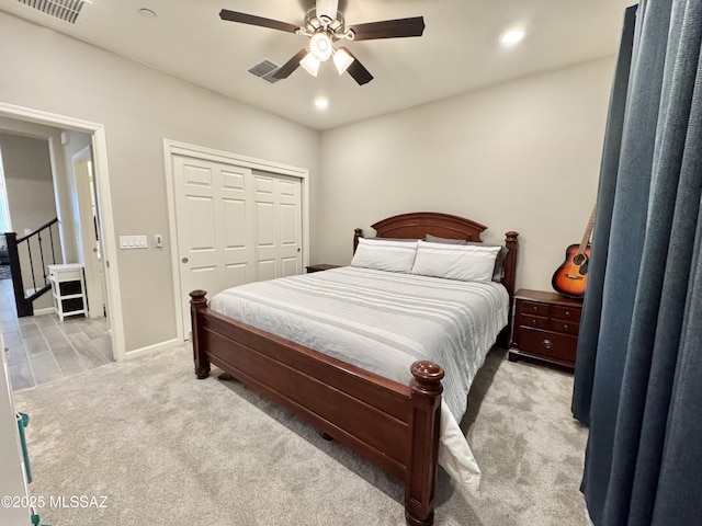 bedroom featuring a ceiling fan, visible vents, a closet, light carpet, and recessed lighting