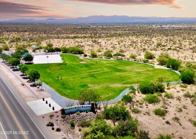 drone / aerial view featuring a rural view, a mountain view, and a desert view